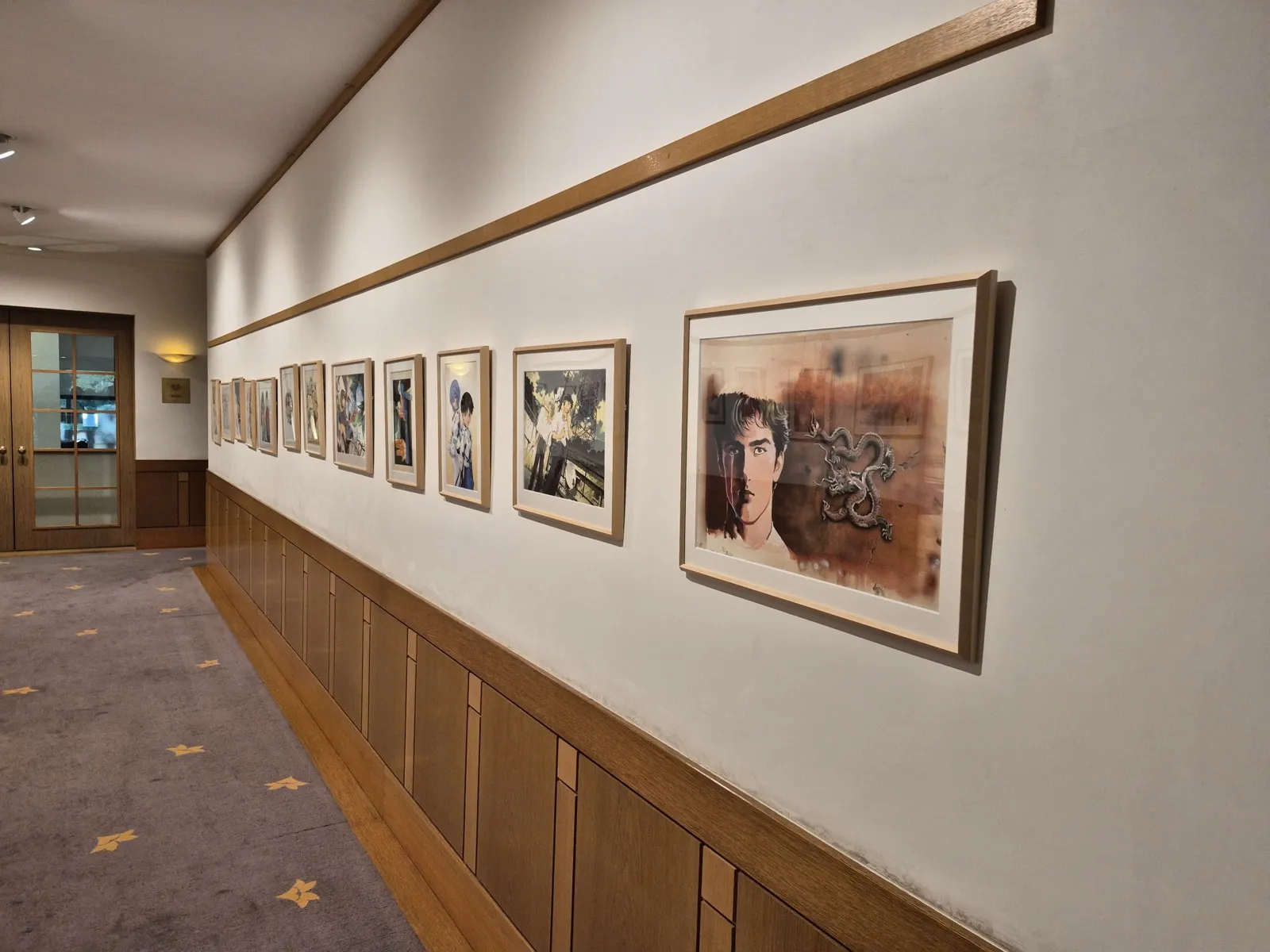 A corridor displaying framed manga artwork